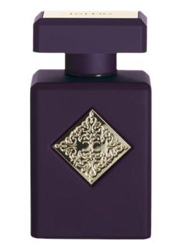 בקבוק בושם סייד אפקט של חברת אינישיו בעיצוב אטרקטיבי סגלגל כהה עם חריטה מוזהבת מוטבעת במרכז הבושם- דוגמיות מוצעות למכירה